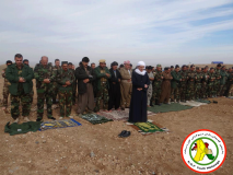 Peshmerga soldiers during praying